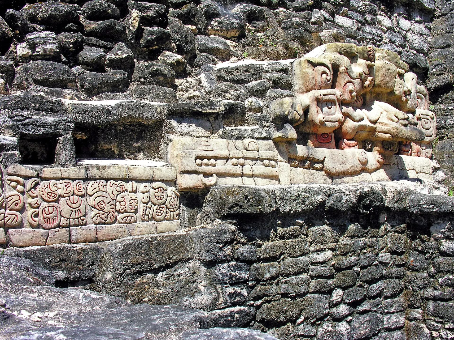 Stucco mask and glyph inscription on Caana pyramid at Maya site of Caracol, Belize